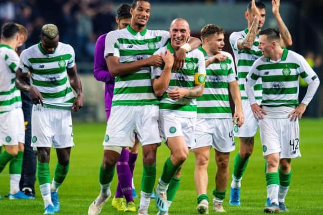 Christopher Jullien, seen here hugging Scott Brown after victory over AIK in Stockholm, says the Celtic squad are rallying around the captain