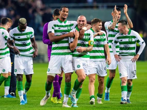 Christopher Jullien, seen here hugging Scott Brown after victory over AIK in Stockholm, says the Celtic squad are rallying around the captain