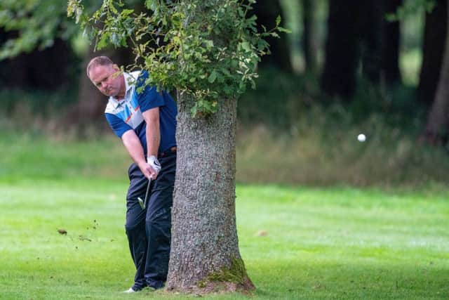Alistair Forsyth plays from behind a tree at Downfield in the Scottish PGA Championship. Picture: Kenny Smith