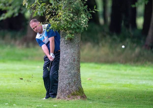 Alistair Forsyth plays from behind a tree at Downfield in the Scottish PGA Championship. Picture: Kenny Smith