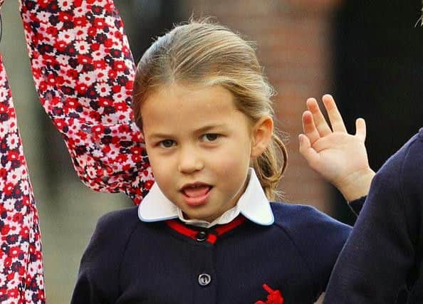 Princess Charlotte smiled and waved to the cameras as she arrived for her first day.