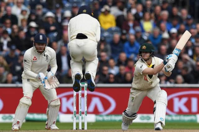 England's Jos Buttler jumps over the ball as Australia's Steve Smith bats his way to a double century. Picture: Paul Ellis/AFP/Getty Images