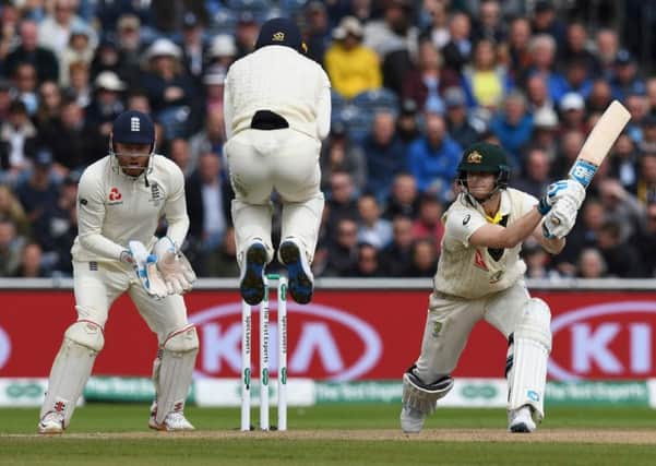 England's Jos Buttler jumps over the ball as Australia's Steve Smith bats his way to a double century. Picture: Paul Ellis/AFP/Getty Images