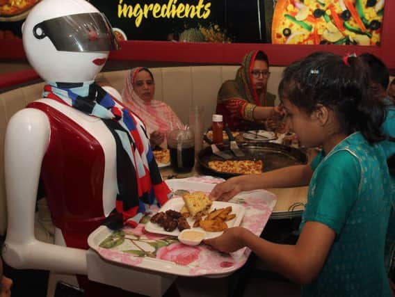 Robot waiters are already used in restaurants around the world including at this pizza parlour in Pakistan. AFP Photo