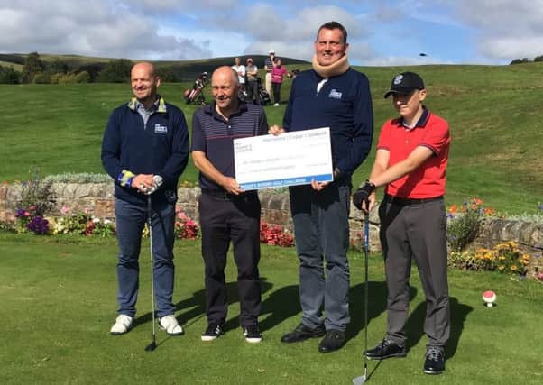 Gregor Townsend, left, and Doddie Weir, second righ't, receive a cheque at Peebles, one of many donations during their Borders golf tour