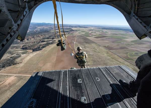 Paras leap from a Chinook helicopter during a military exercise. Picture: Ministry 
of Defence