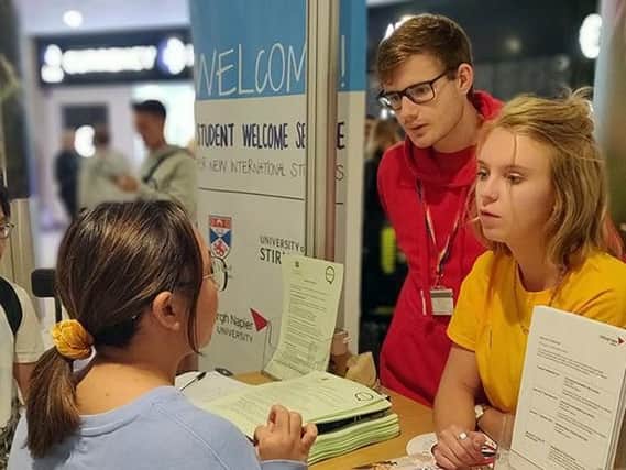 Volunteers at the Scottish Universities welcome desk greet new students at Edinburgh Airport. Picture: The University of Edinburgh.