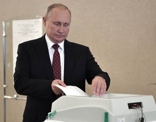 Russian President Vladimir Putin casts his ballot at a polling station during a city council election in Moscow. (Alexei Nikolsky, Sputnik, Kremlin Pool Photo via AP)