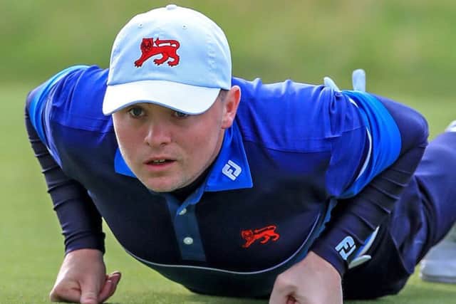 Alex Fitzpatrick gets the lowdown on a putt during the first session in the 47th Walker Cup at Royal Liverpool. Picture: PA