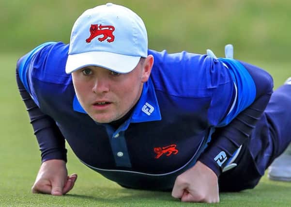 Alex Fitzpatrick gets the lowdown on a putt during the first session in the 47th Walker Cup at Royal Liverpool. Picture: PA
