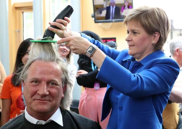 First Minister Nicola Sturgeon cuts the hair of David Torrance MSP raising £1000 for the charity Maggie's Centre in Kirkcaldy this week. The party says it is 'relishing' the prospect of an election. Picture: Andrew Milligan/PA Wire