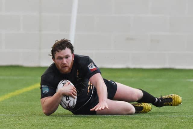 Currie's Fergus Scott goes over to score a try