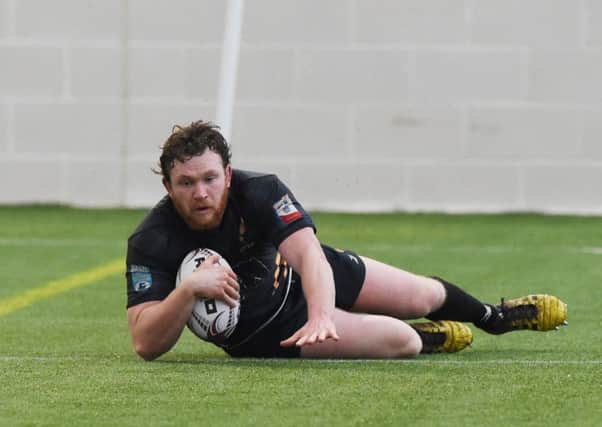 Currie's Fergus Scott goes over to score a try