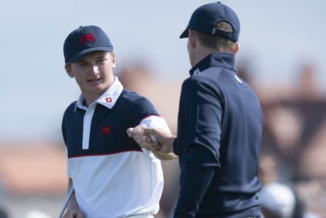 Sandy Scott fistpumps GB&I team-mate Euan Walker on their way to sharing a point on the second morning of the 47th Walker Cup. Picture: AP
