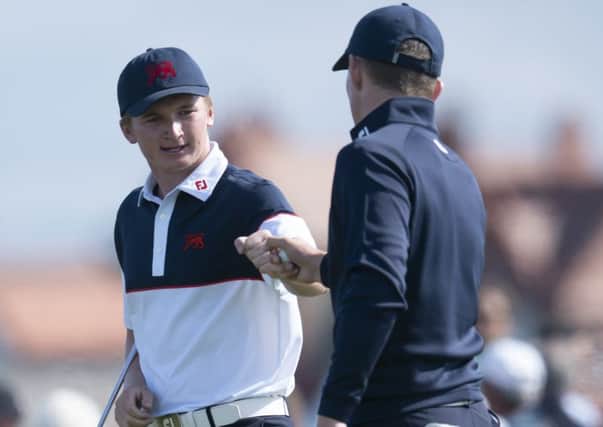 Sandy Scott fistpumps GB&I team-mate Euan Walker on their way to sharing a point on the second morning of the 47th Walker Cup. Picture: AP