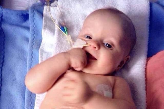 Evan had his first chemotherapy session at just 12 days old after a sharp eyed midwife spotted a swelling in his stomach minutes after he was born.
