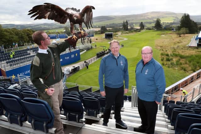 Solheim Cup Tournament Director Ross Hallett and Visit Scotland's Paul Bush with Albus, a 3 year old male golden eagle, and falconer Duncan Eade in the stands on the 1st tee at Gleneagles. Picture: Stewart Attwood