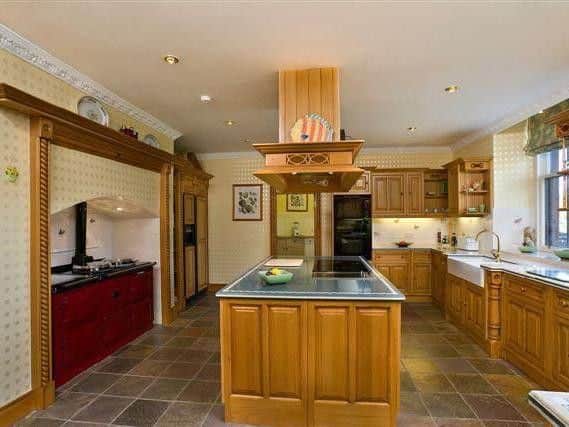 The traditional style kitchen has a large AGA range.