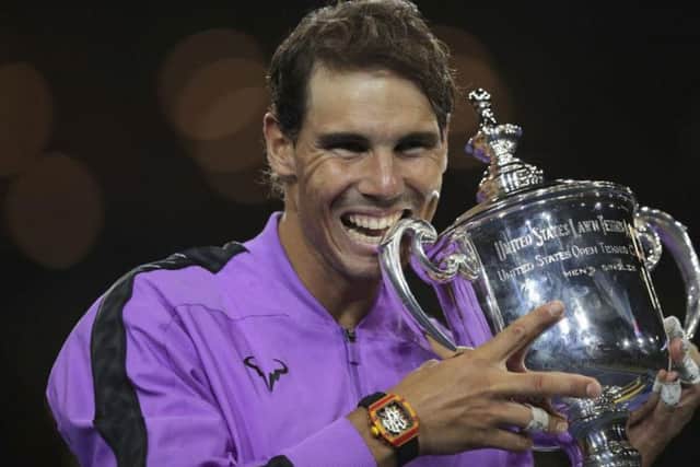 Rafael Nadal smiles as he poses with the US Open trophy