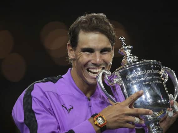 Rafael Nadal smiles as he poses with the US Open trophy