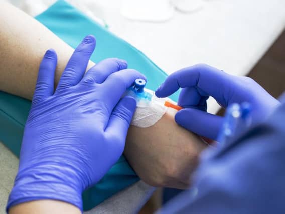 A nurse inputs a catheter to a patient for a drip of chemotherapy. Picture: Getty