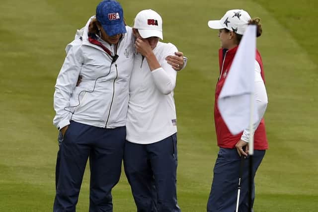 US captain Juli Inkster consoles a tearful Stacy Lewis, one of her wildcards, after the former Womens British Open appeared to hurt herself playing a shot in a practice round at Gleneagles.  Inkster was first on the scene in her buggy before other US players arrived to also give Lewis a hug. Picture: Ian Rutherford/PA Wire