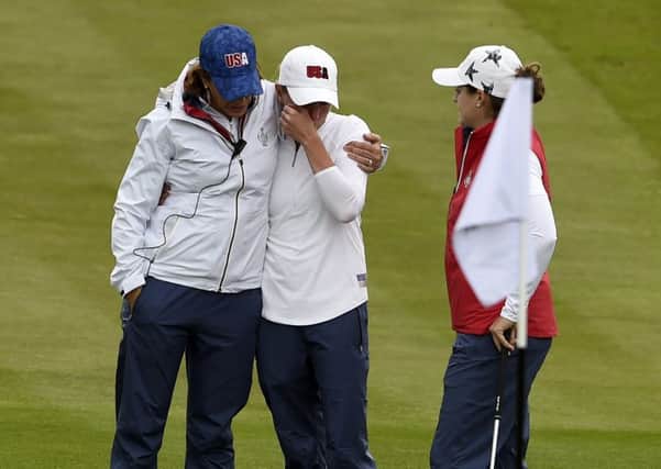 US captain Juli Inkster consoles a tearful Stacy Lewis, one of her wildcards, after the former Womens British Open appeared to hurt herself playing a shot in a practice round at Gleneagles.  Inkster was first on the scene in her buggy before other US players arrived to also give Lewis a hug. Picture: Ian Rutherford/PA Wire