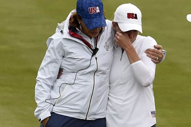 US captain Juli Inkster consoles a tearful Stacy Lewis during Monday's practice round after realising she would have to withdraw from the Solheim Cup due to a back injury. Picture: Ian Rutherford/PA