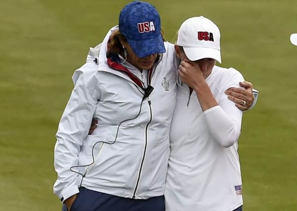 US captain Juli Inkster consoles a tearful Stacy Lewis during Monday's practice round after realising she would have to withdraw from the Solheim Cup due to a back injury. Picture: Ian Rutherford/PA