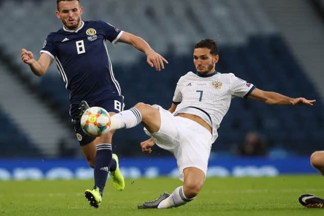 John McGinn vies with Russias Magomed Ozdoev during a 2-1 defeat. Worse was to follow against Belgium (Picture: Ian MacNicol/Getty Images)