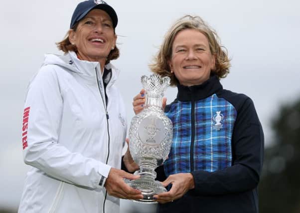 Team captains Juli Inkster, left, and Catriona Matthew pose with the Solheim Cup trophy.