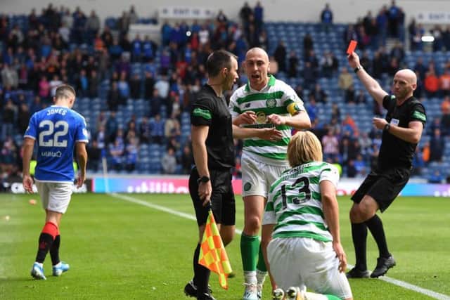 Referee Bobby Madden sends off Rangers' Jordan Jones after his wild challenge on Moritz Bauer of Celtic. Picture: Craig Williamson/SNS