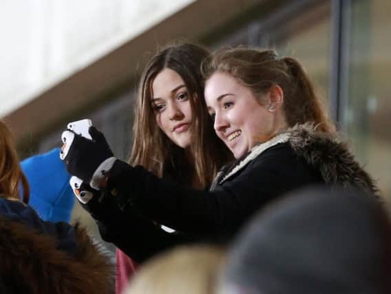 One Direction Louis Tomlinson's sister Felicite Tomlinson (left) with fans at Doncaster Rovers Keepmoat Stadium in 2014.