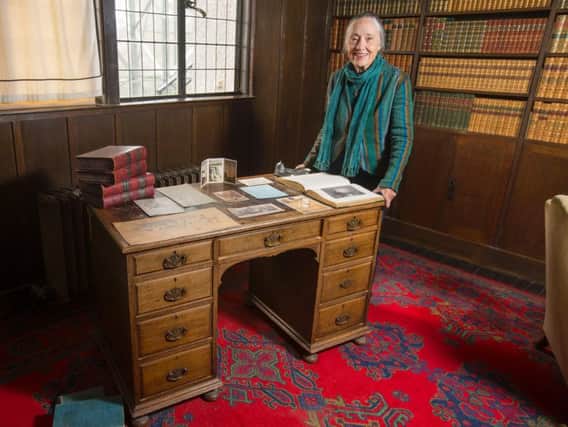 Ruth Currie, the granddaughter of Walter Blackie, with the desk which is now back in the library at The Hill House, which was designed by Charles Rennie Mackintosh for the publisher. PIC: NTS