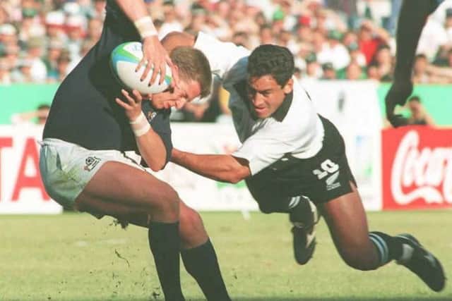 All Blacks fly-half Andrew Mehrtensull tackles Scotland's Craig Chalmers at the 1995 World Cup quarter-finals in Pretoria. Picture: Walter Dhladhla/AFP/Getty Images