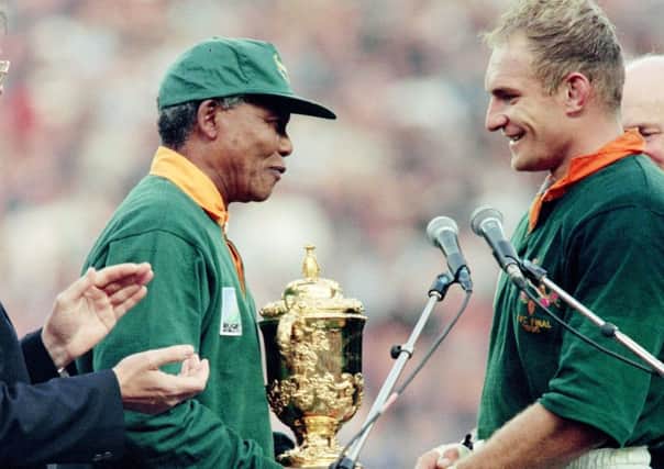 June 1995, South Africa president Nelson Mandela congratulates Springbok skipper François Pienaar after handing him the William Webb Ellis trophy. Picture: Jean-Pierre Muller/AFP/Getty Images