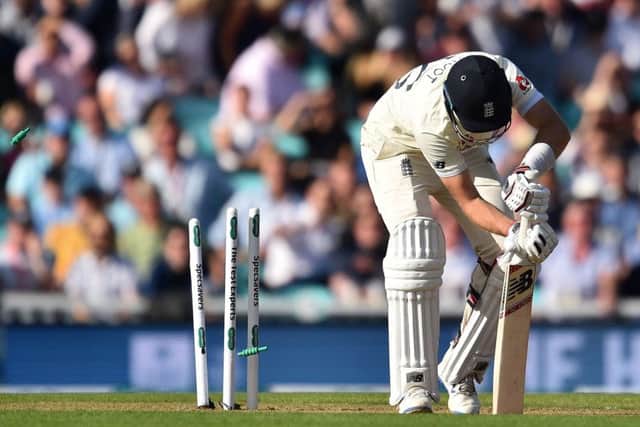 The bails fly as England captain Joe Root is bowled by Pat Cummins. Picture: Glyn Kirk/AFP/Getty
