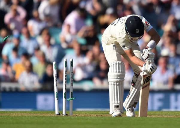 The bails fly as England captain Joe Root is bowled by Pat Cummins. Picture: Glyn Kirk/AFP/Getty