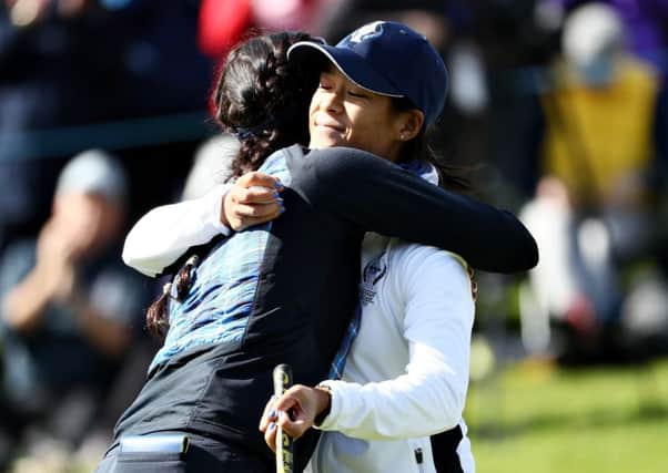Rookie Celine Boutier, right, is hugged by Georgia Hall after their win in the opening session in the Solheim Cup at Gleneagles. Picture: Getty Images