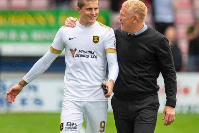 Gary Holt congratulates striker Lyndon Dykes. Picture: SNS