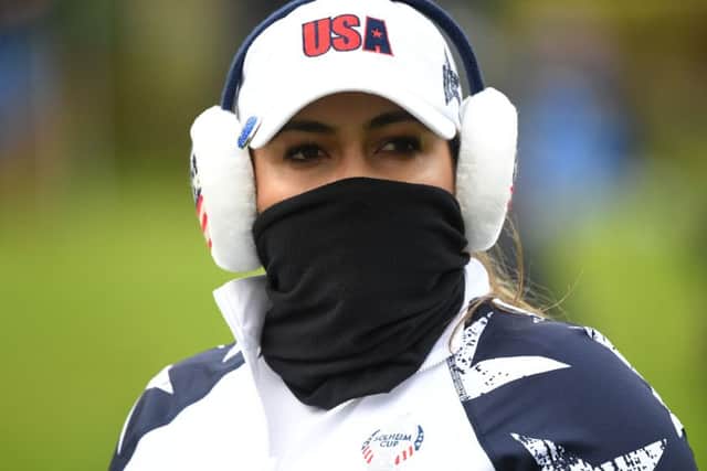 American Lizetta Salas wraps up to combat the cold on the second morning in the 16th Solheim Cup at Gleneagles. Picture: AFP