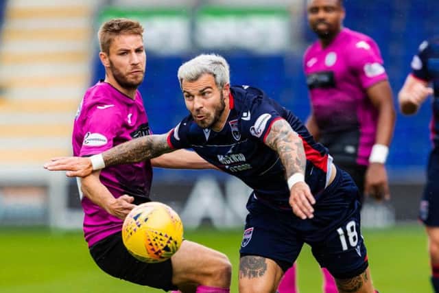 Richard Foster battles for the ball in Ross County's win.