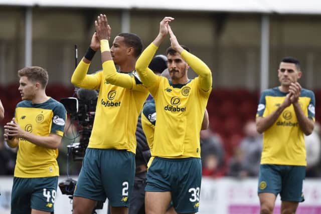 Christopher Jullien, centre left, and Hatem Abd Elhamed applaud the Celtic fans after their win in Hamilton. Picture: Rob Casey/SNS