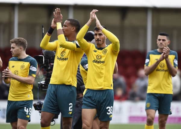 Christopher Jullien, centre left, and Hatem Abd Elhamed applaud the Celtic fans after their win in Hamilton. Picture: Rob Casey/SNS