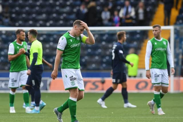 Hibs skipper Paul Hanlon feels the strain at the end of the match on Saturday. Picture: SNS.