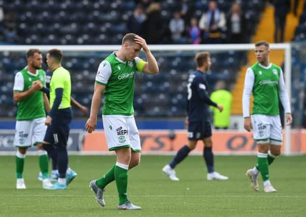 Hibs skipper Paul Hanlon feels the strain at the end of the match on Saturday. Picture: SNS.