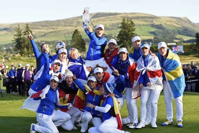 European captain Catriona Matthew holds the Solheim Cup aloft as she is lifted up by her team after their dramatic last-hole victory over Team USA at Gleneagles. Picture: Ian Rutherford/PA