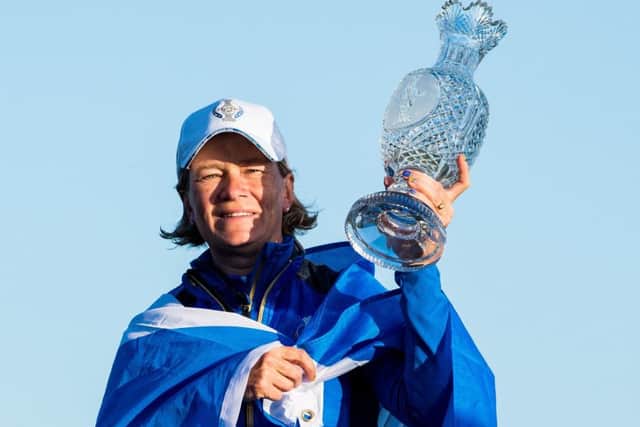 Catriona Matthew celebrates with the trophy after Europe's victory in the Solheim Cup. Picture: SNS.