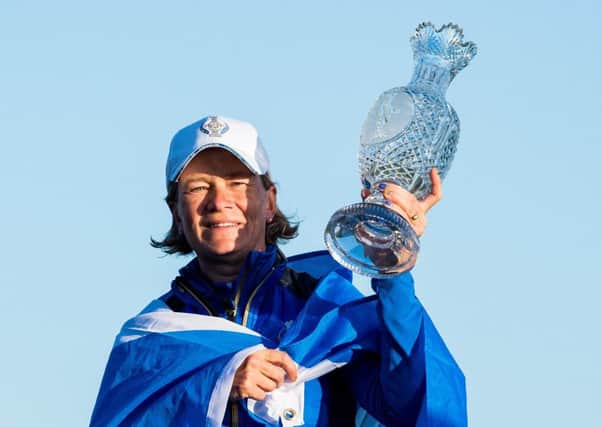 Catriona Matthew celebrates with the trophy after Europe's victory in the Solheim Cup. Picture: SNS.