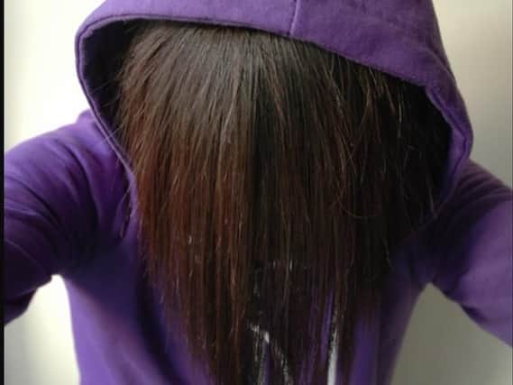 The 'pale' teen was described as having a long fringe - like the one posed by the model pictured - with purple highlights.